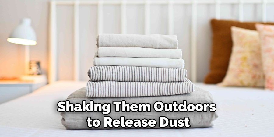 Shaking Them Outdoors 
to Release Dust