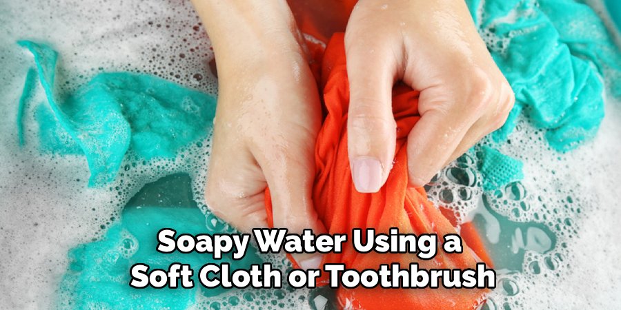 Soapy Water Using a 
Soft Cloth or Toothbrush