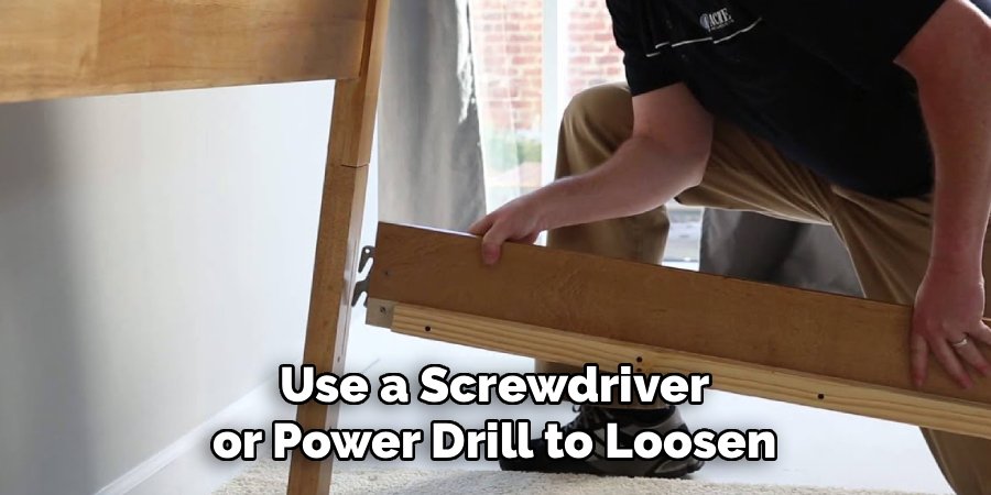 Use a Screwdriver or Power Drill to Loosen